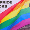 Image of Pride Flag with collaged images of two men marrying and collaged lips and stars.